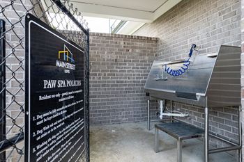 a barbershop with a sign in front of a brick wall